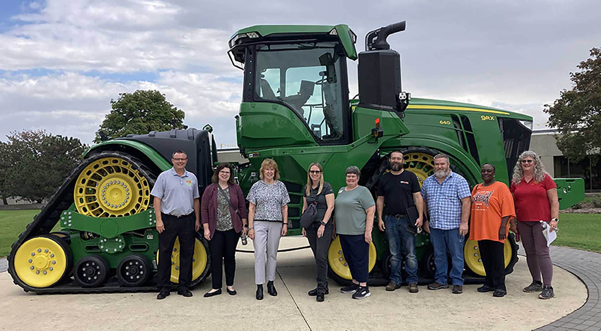 Advisory board lined up in front of a machine.